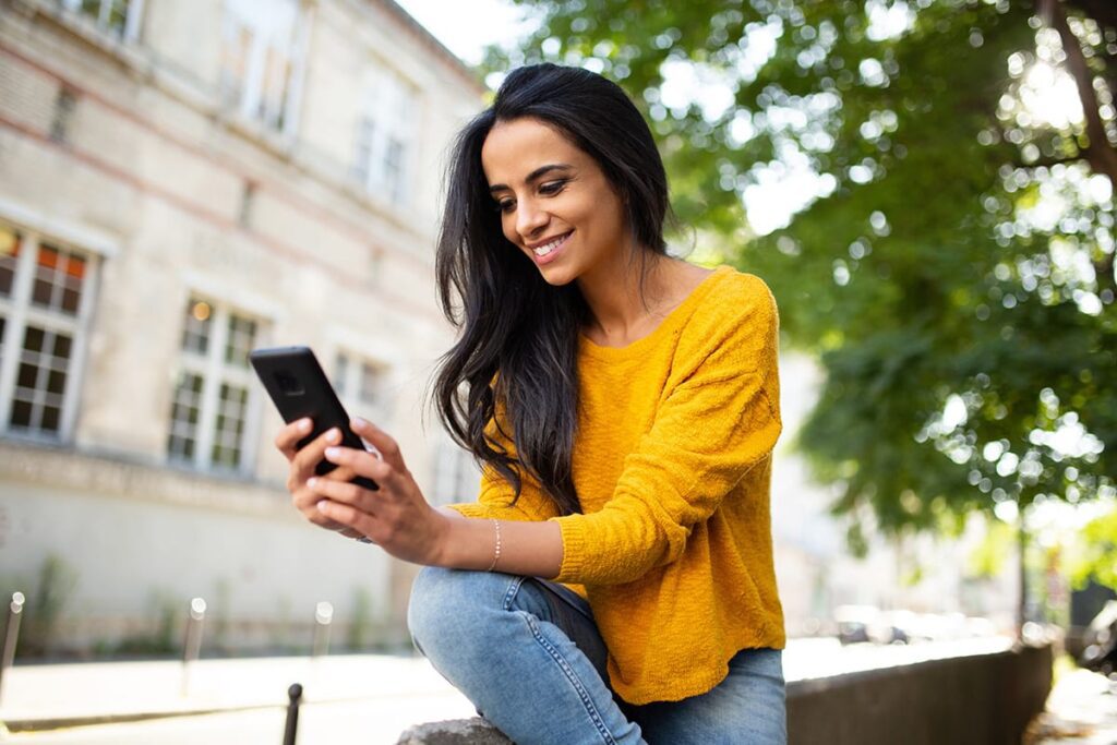 a person uses their phone to research Sober Stadiums